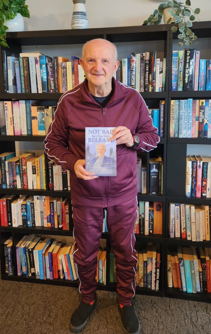Fred Thompson holding his memoir in the Precinct library